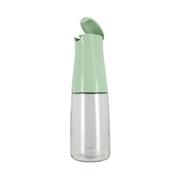 Bouteille d'huile 500ml Menastyl en verre transparent avec bec verseur vert, capuchon ouvert sur fond blanc