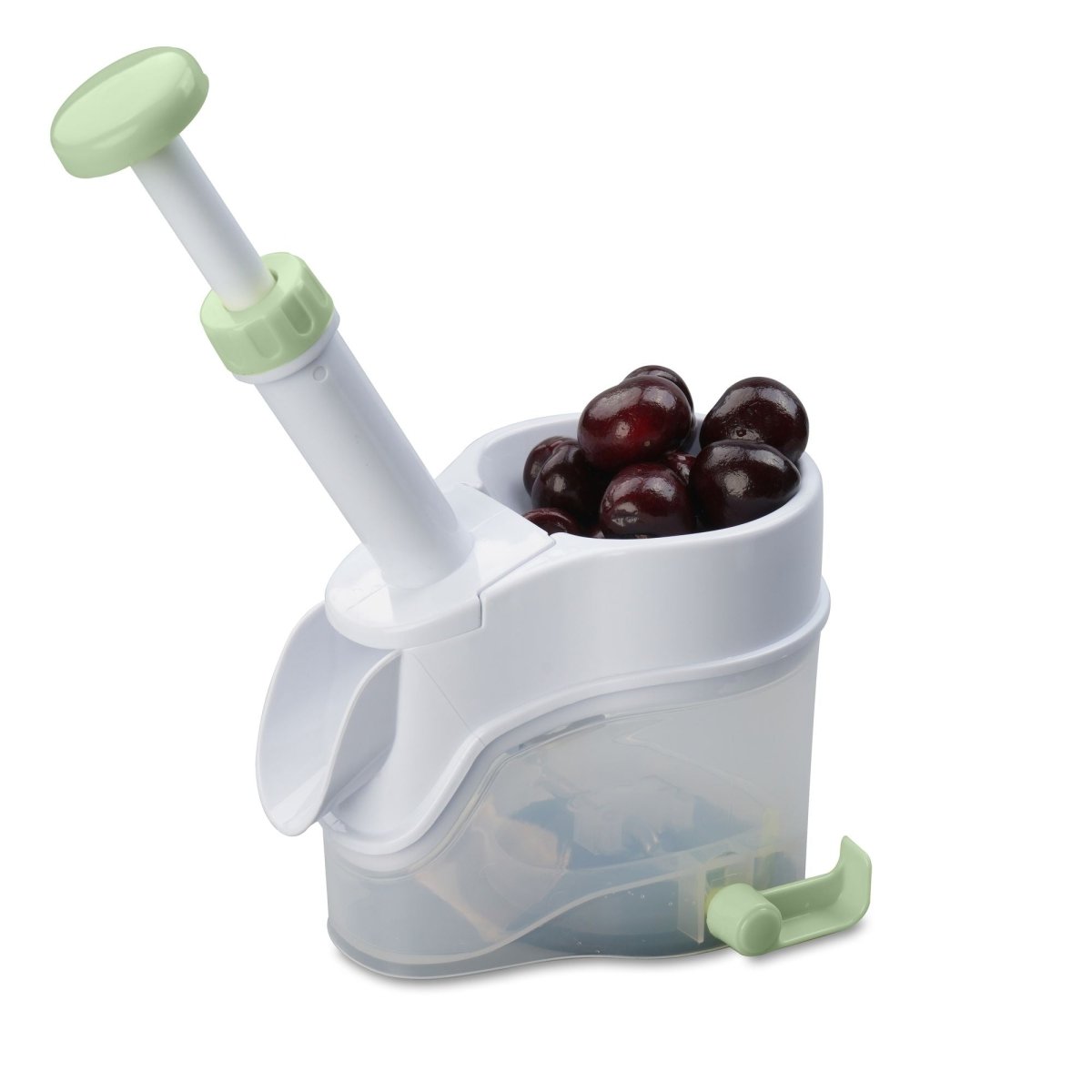 Dénoyauteur à cerises Menastyl en plastique blanc et vert, avec mécanisme à ressort et récipient transparent contenant des cerises