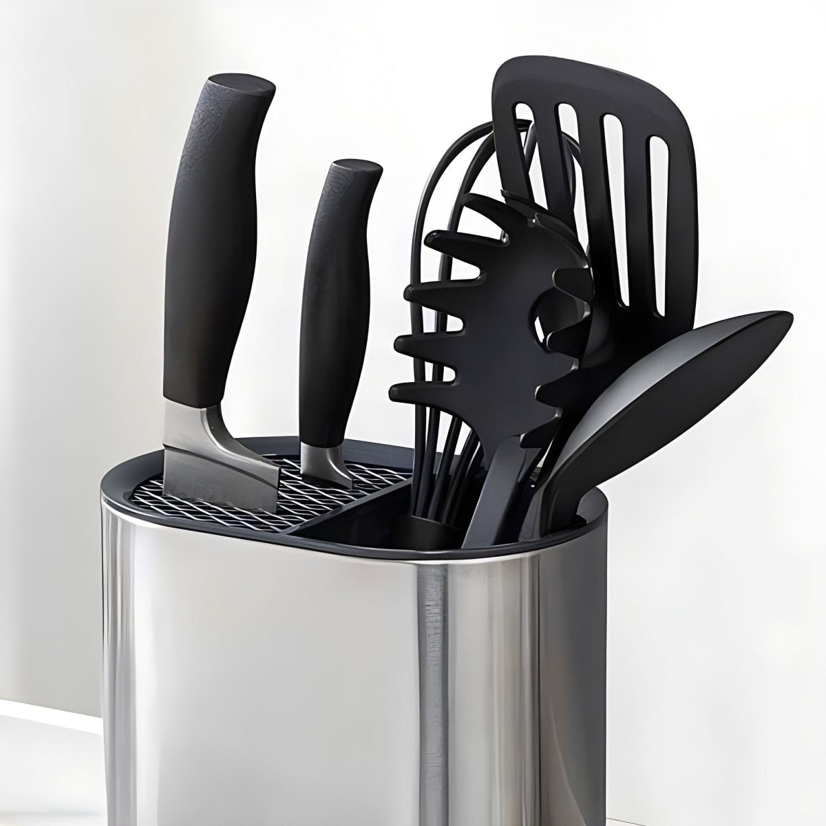 Porte-ustensiles cylindrique en inox brossé rempli d'ustensiles de cuisine noirs, vue latérale détaillée